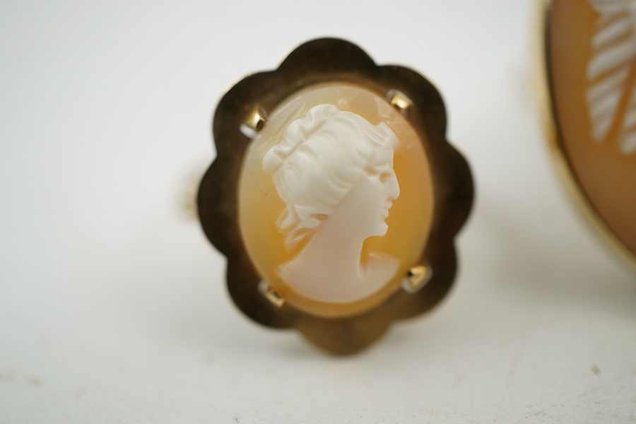 A group of three shell cameo rings, two depicting a classical lady in profile, one of navette-shaped outline depicting a dancing figure, each mounted in gold, two stamped 9ct, largest size V, largest cameo 3 x 2.4cm, com